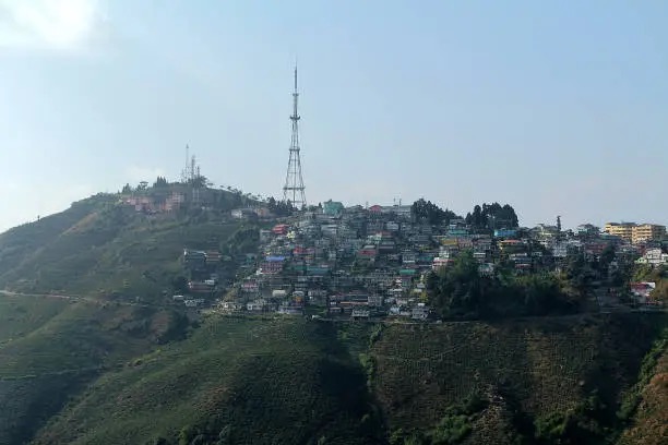 A hill town spread along a ridge above tea slopes on the descent from Darjeeling