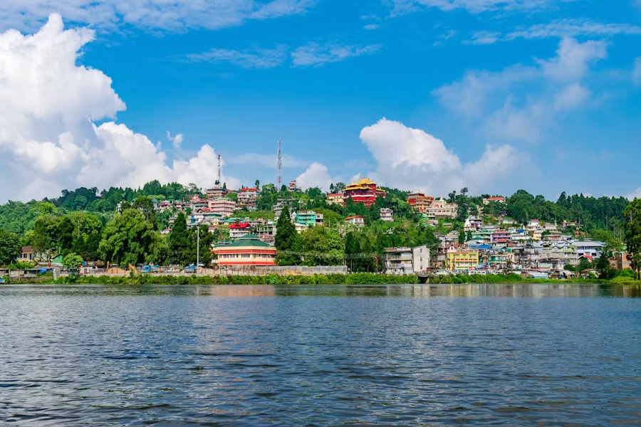 Mirik Lake with the town and a monastery on the wooded hillside behind